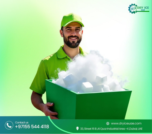 A professional delivery person from Dry Ice UAE wearing a green uniform and cap, holding a large green container filled with high-purity dry ice blocks and sublimating vapor.