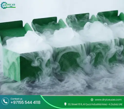Green insulated boxes filled with dry ice blocks emitting cold vapor, provided by a dry ice supplier in Dubai.